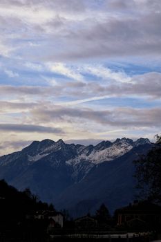 Beautiful snow capped mountains under a cloudy sky in Chiavenna, Lombardy, Italy. 30095986