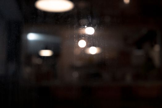 A dark abstract image showcasing blurred bokeh lights with a moody atmosphere.