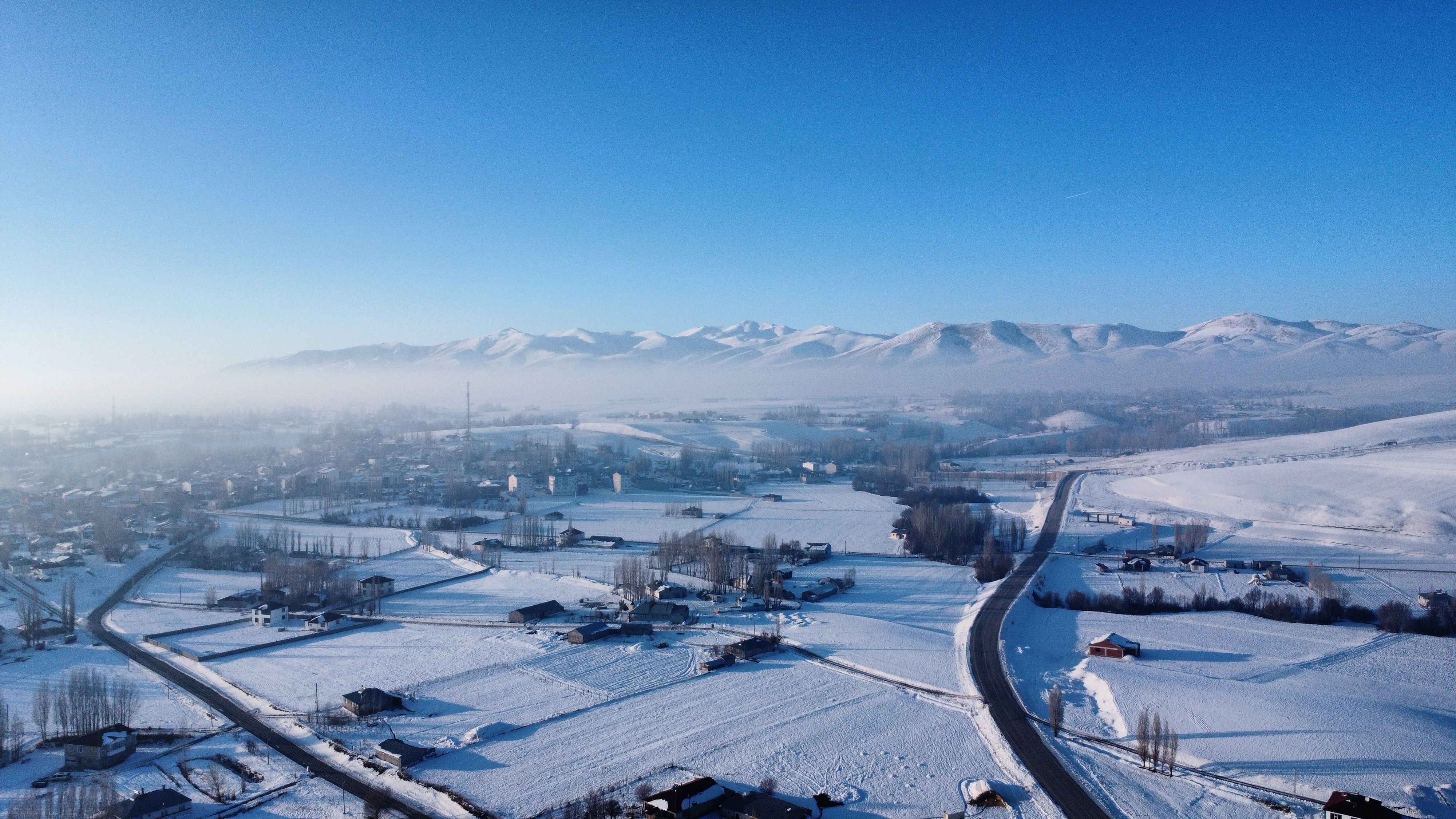 Snowy Rural Landscape with Distant Mountains · Free Stock Photo