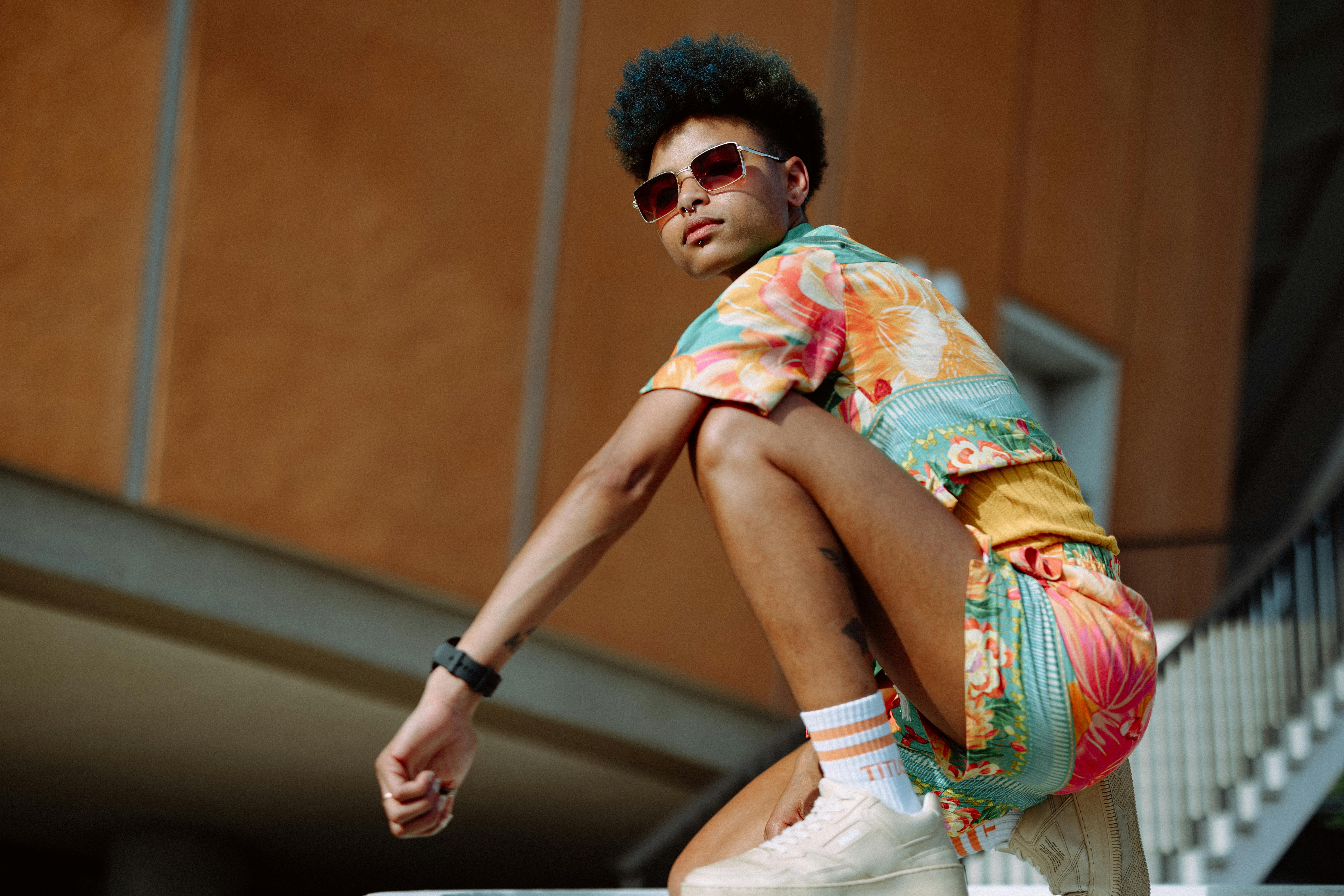Stylish individual in vibrant clothing poses confidently outdoors in Berlin, Germany.