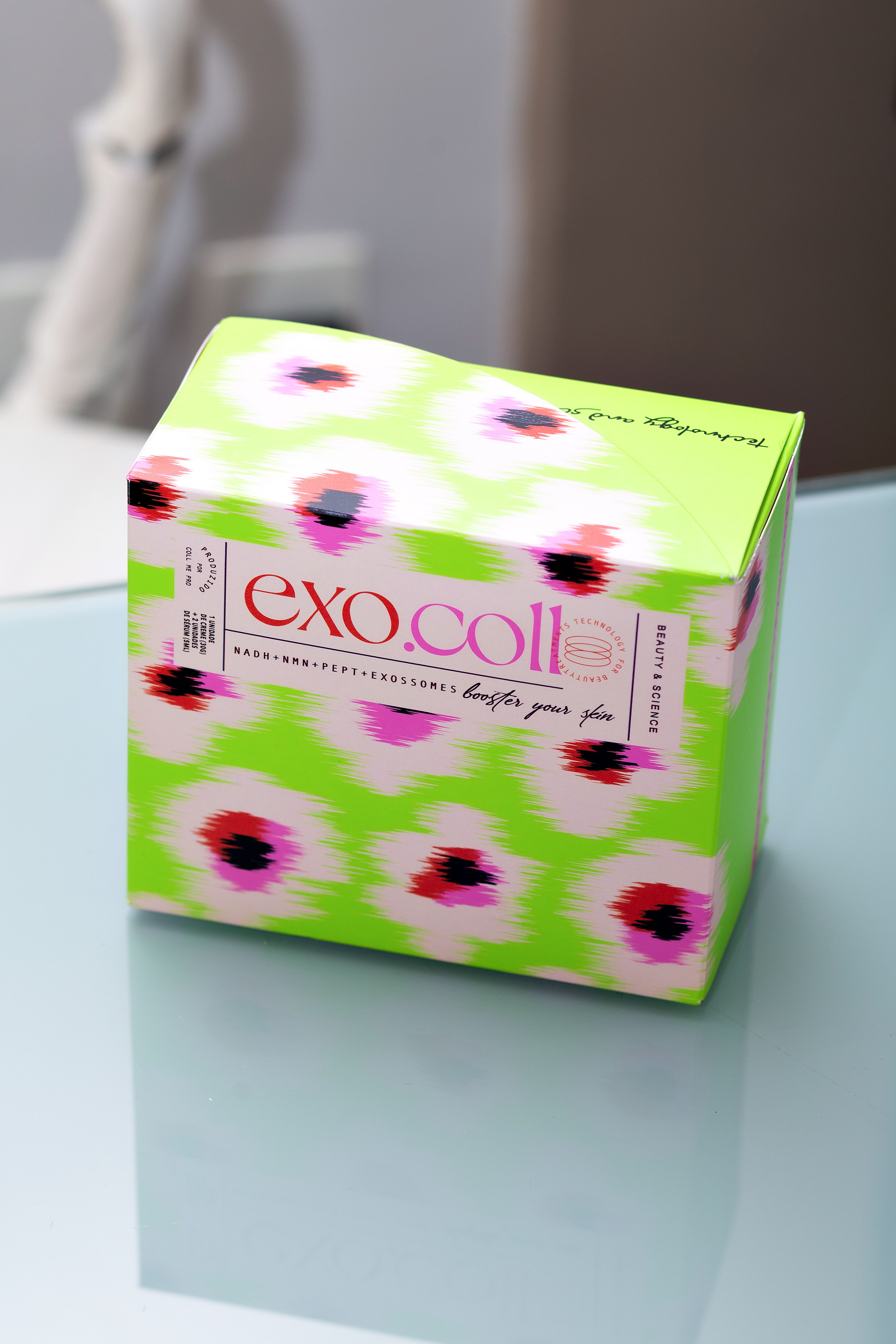 Vibrant Exo Coll Packaging on Glass Table · Free Stock Photo