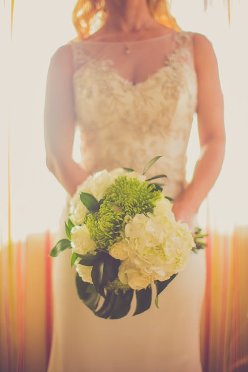 Close-up Photo Bride Holding Bouquet of Flowers