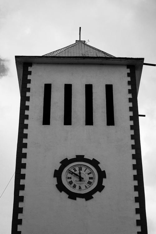 Free Black and white photo of a classic clock tower with Roman numerals in Metlaltoyuca, Puebla, Mexico. Stock Photo