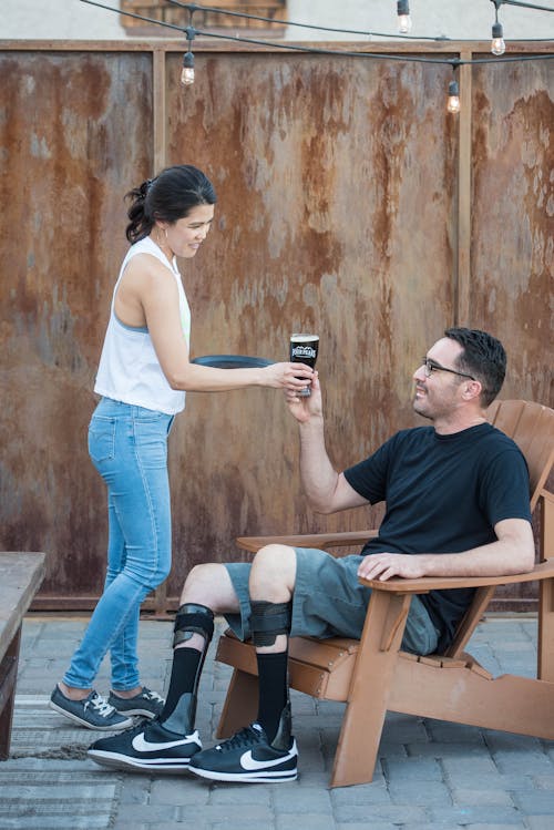 Man Wearing Black Crew Neck T-shirt Sitting On Adirondack Chair