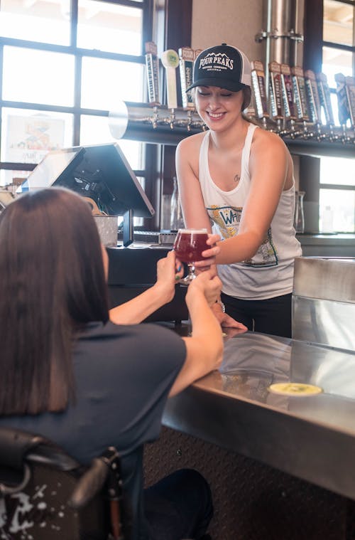 Bartender Serving a Cold Glass of Beer