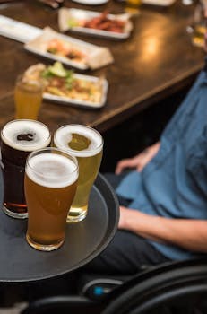 A selection of beers on a tray set in a lively restaurant atmosphere, highlighting social dining.