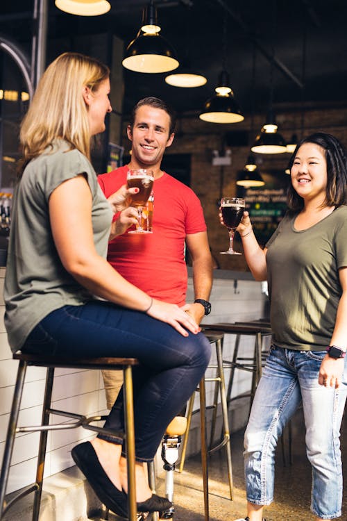 Three People Having Conversation Inside Bar 