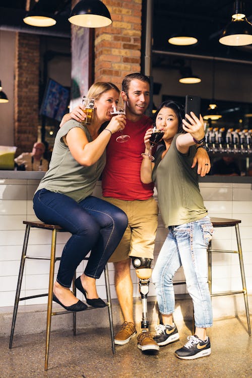 People Taking a Selfie While Drinking Beer