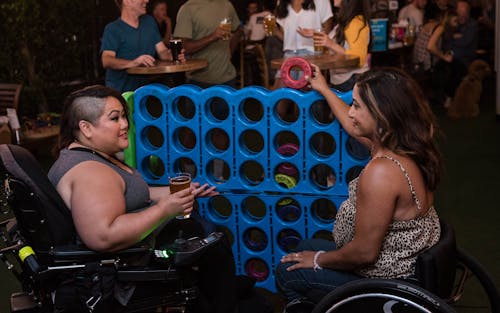 Women Playing Connect Four in a Bar