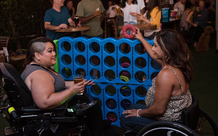 Women Playing Connect Four In A Bar