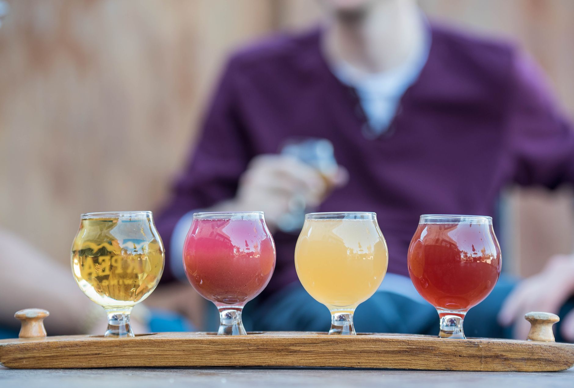 Pouring beer into a tulip shaped beer glass with a foamy head