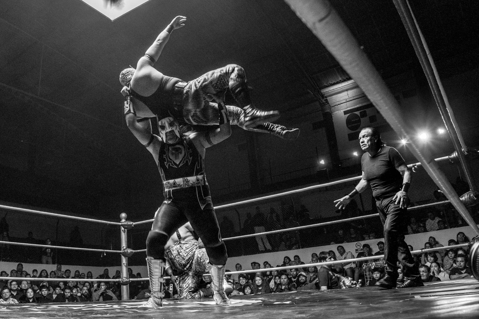 Thrilling black and white capture of a Lucha Libre wrestling match in Mexico.