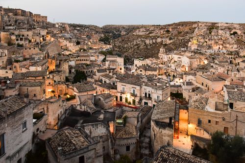 Free Breathtaking view of Matera's ancient stone cityscape under twilight, Italy. Stock Photo