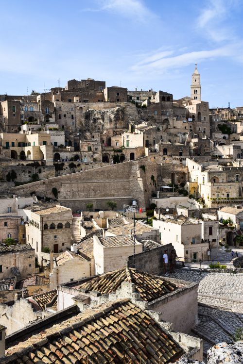 Free A scenic view of the historic hilltop architecture of Matera, Italy, under a clear blue sky. Stock Photo
