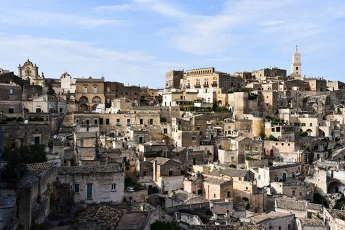 Free Breathtaking view of Matera's ancient stone buildings under a clear blue sky. Stock Photo