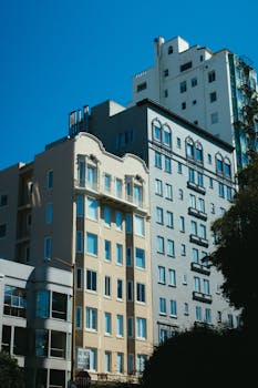 Vibrant building facades with diverse architectural styles under a clear blue sky.
