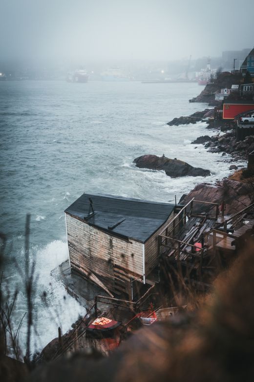 Misty coastal house on a rocky shore by Jonathan Cooper on Pexels