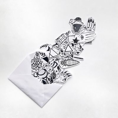 Monochrome artistic stickers spilling from an envelope — photo by Florencia Ceruti on Pexels