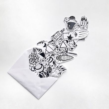 Ink-drawn sticker sheets spilling from an envelope — photo by Florencia Ceruti on Pexels