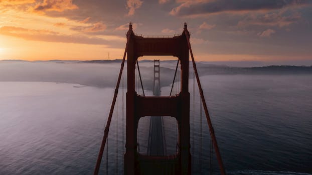 Stunning aerial view of the Golden Gate Bridge at sunrise over San Francisco Bay.