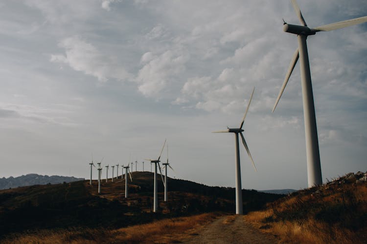 Wind Turbines Under A Cloudy Sky