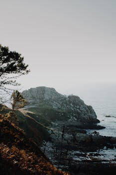 黎明时分，在美丽的沿海悬崖上拍摄，可欣赏朦胧大气中的海景与岩石