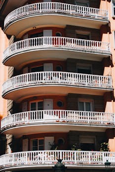 Curved balconies on a modern apartment building captured in daylight, showcasing architectural design.