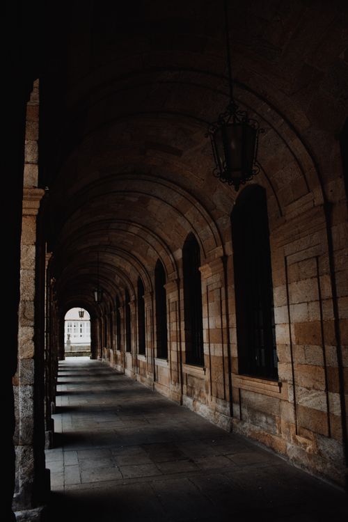 Free Dramatic arched hallway inside a historic building, showcasing gothic architecture. Stock Photo