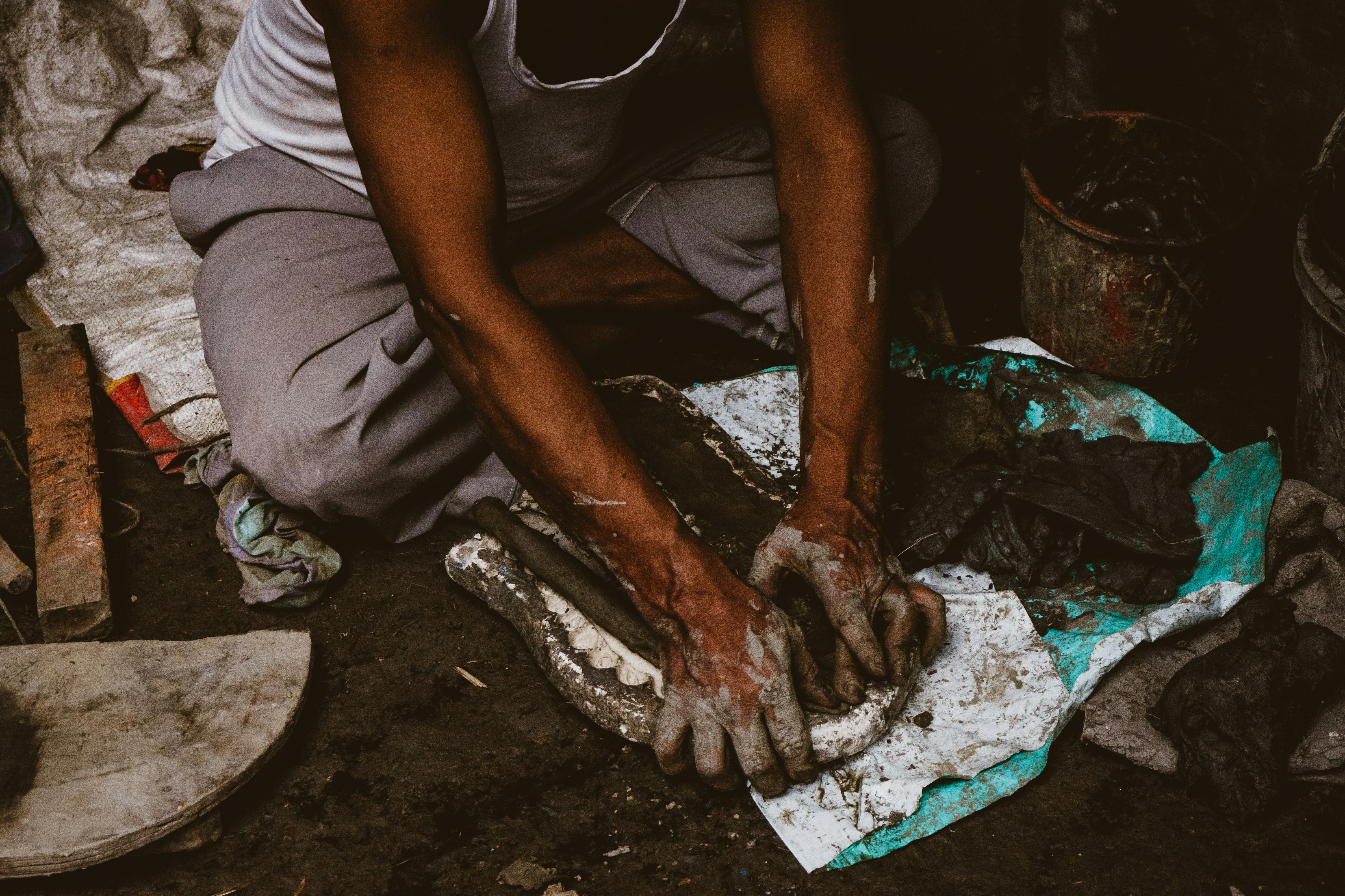 man working with clay soil