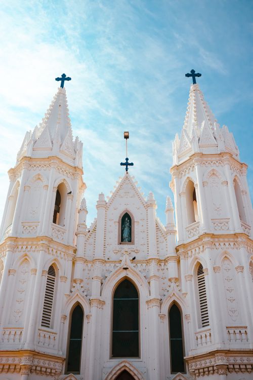 Free Stunning view of a Gothic cathedral with twin spires under a vibrant blue sky. Stock Photo
