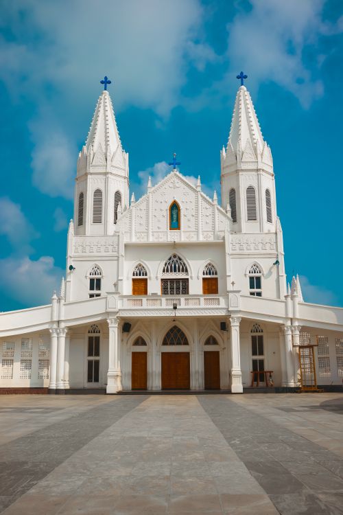 Free Stunning white church with twin towers under a clear blue sky, showcasing Gothic architecture. Stock Photo