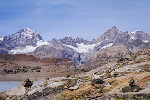 Breathtaking view of a rugged alpine mountain range, featuring snow-capped peaks and rocky terrain.