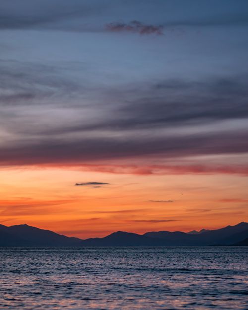 Free Dramatic sunset over Lake Ohrid, Macedonia with vibrant sky and tranquil water reflection. Stock Photo