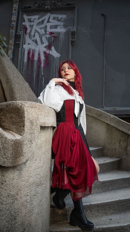 Free Outdoor fashion portrait of a woman with red hair in a vintage-inspired dress in Istanbul. Stock Photo