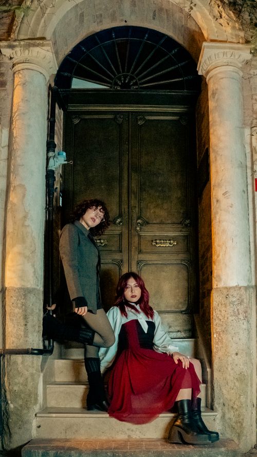 Free A stylish portrait of two adults posing on historic steps in Istanbul, Türkiye. Stock Photo