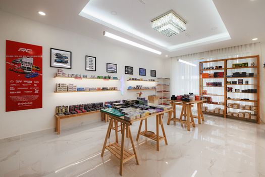 Interior of a sleek diecast and RC model store in Phnom Penh, showcasing various model cars and store design.