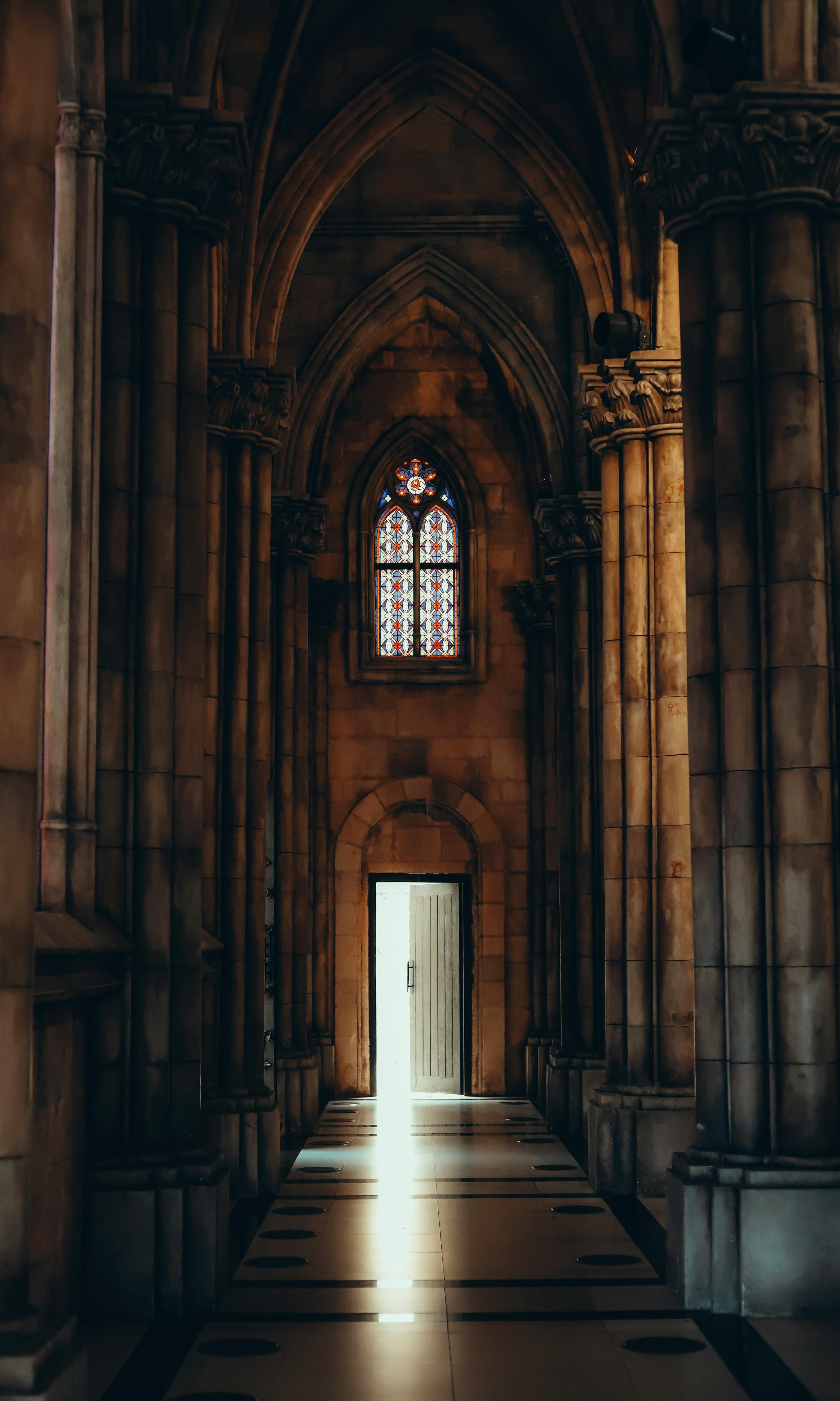 Stunning view of a Gothic cathedral interior with a beam of light through stained glass window.
