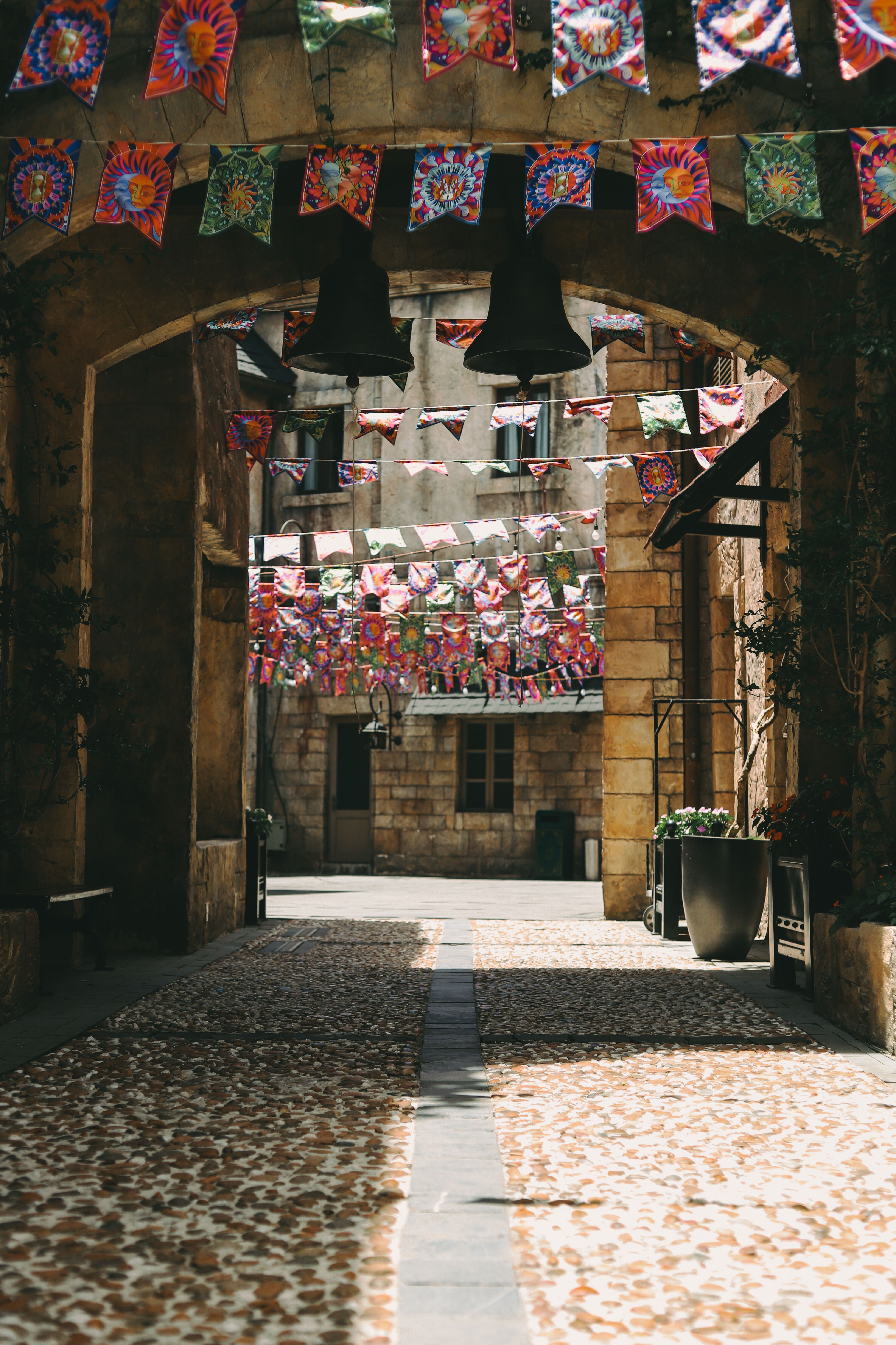 Charming Alley with Colorful Festival Banners · Free Stock Photo