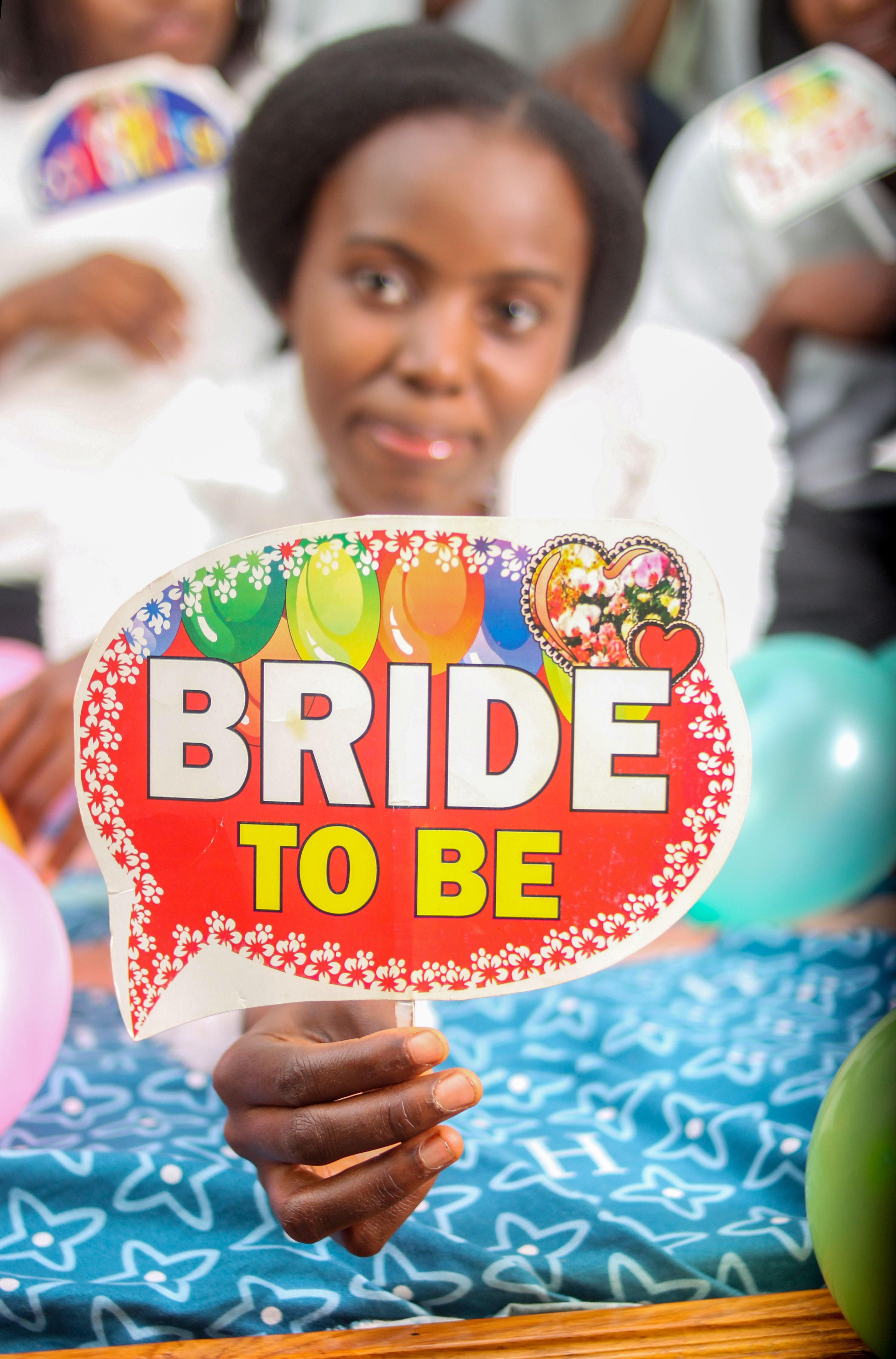 Colorful bridal shower celebration with balloons and bride-to-be sign in Jos, Nigeria.