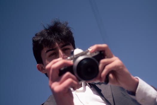 Confident man in vintage attire taking photos on Buenos Aires streets.