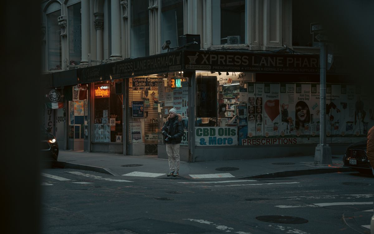 A quiet city street corner at night under low light