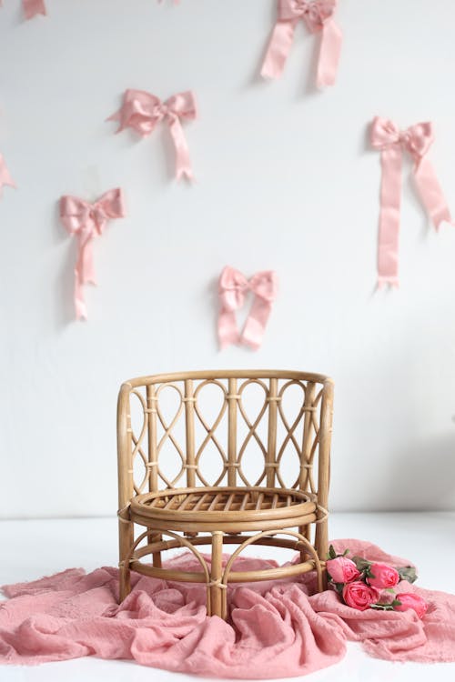 Charming Rattan Chair with Pink Decor Setup · Free Stock Photo