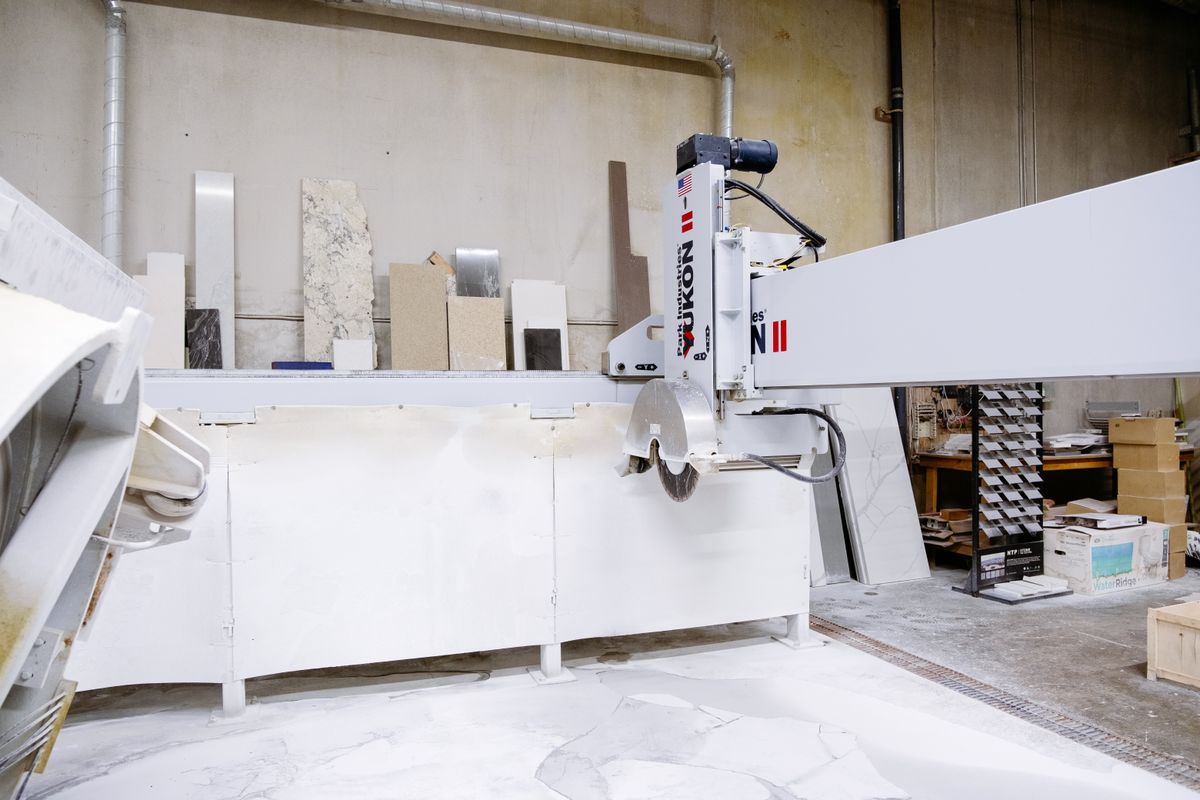 Machine cutting granite slab