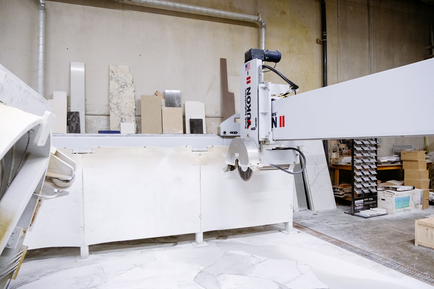 Industrial stone cutting equipment inside a fabrication workshop