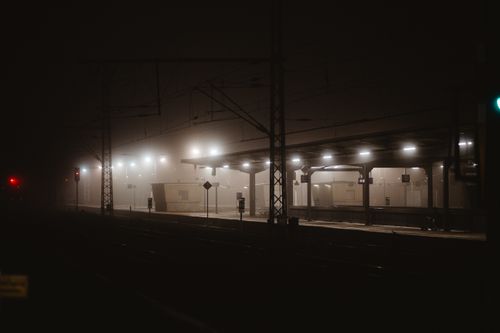 Berlin train station at night shrouded in dense atmospheric fog.