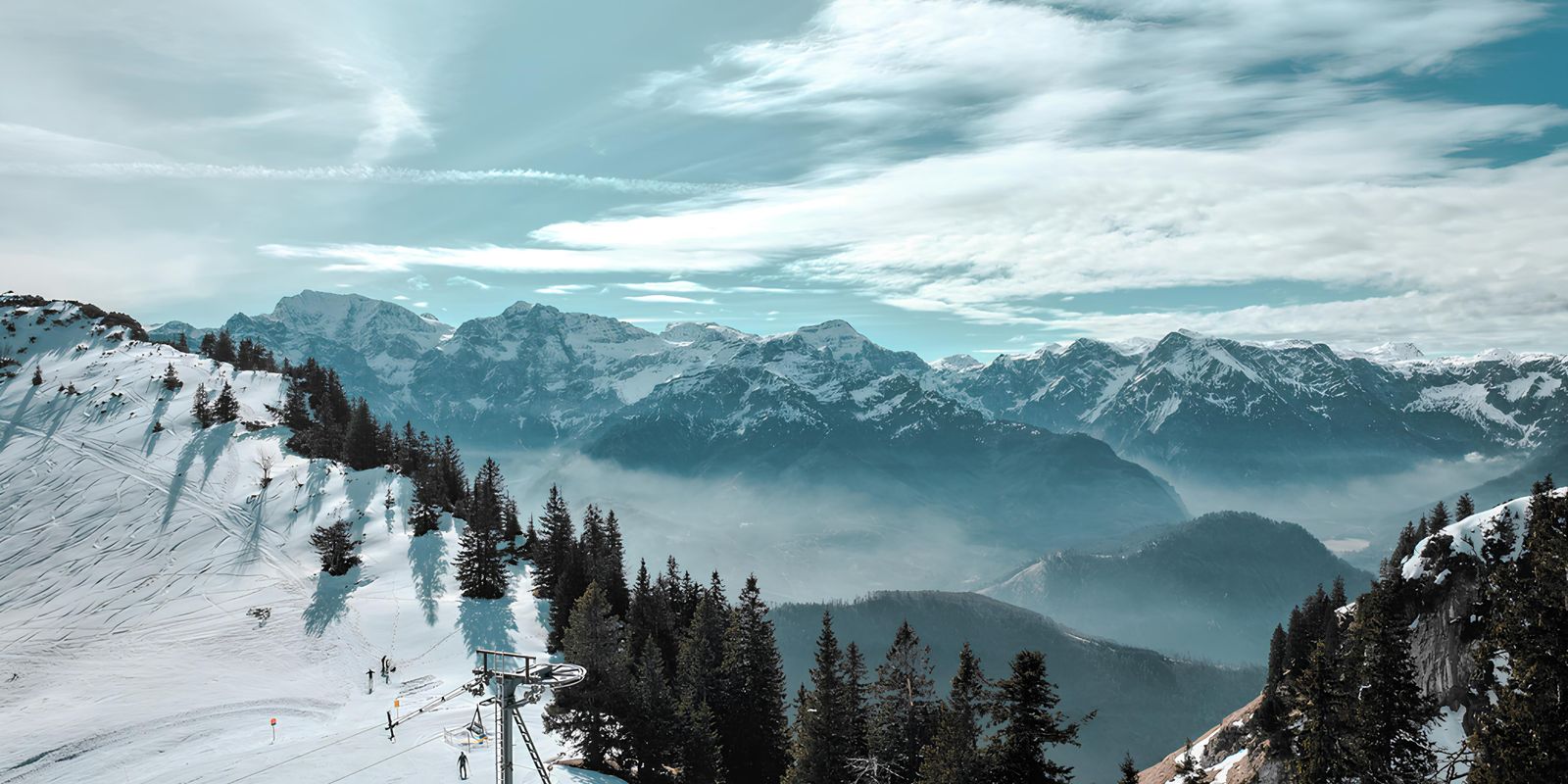 Skiers on a snowy mountain slope in an alpine setting