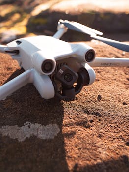Detailed shot of a drone resting on a rocky surface in natural light.