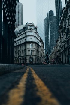 Urban street view of London's mix of historic and modern architecture in moody lighting.