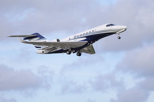 Free A sleek private jet ascending into the sky with clouds in the background. Stock Photo