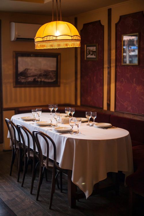 Free Elegant dining setup in a cozy restaurant with warm lighting and classic decor. Stock Photo
